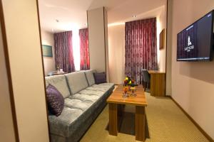 a living room with a couch and a table at Sayyoh Hotel in Tashkent