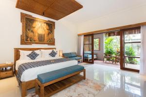 a bedroom with a king sized bed in a room at Bije Boutique & Gallery in Ubud +41 photos
