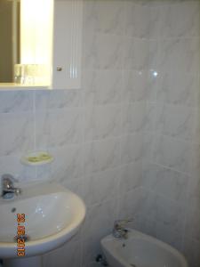 a white bathroom with a sink and a toilet at Hostal Vadama in Segovia +25 photos