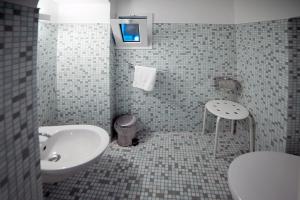 a bathroom with a sink and a toilet at B&B Al Duomo Molfetta in Molfetta +11 photos