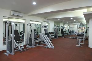 a gym with lots of treadmills and machines at Grand Heritage Narmada Jacksons in Jabalpur