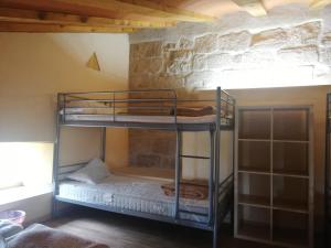 a bunk bed room with two bunk beds against a wall at Casón Salto de Roldán in Sabayés