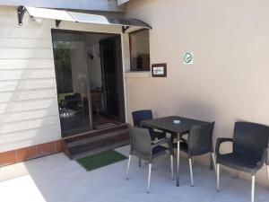 a patio with a table and chairs next to a building at Rustverseker Self Catering Accommodation in George
