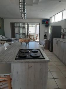 a kitchen with a stove top on a counter at Bergsight Self Catering Accommodation in George