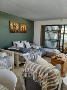 a living room with three beds and a couch at Bergsight Self Catering Accommodation in George
