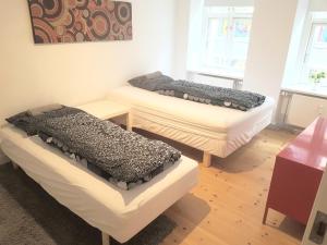 a room with three beds and a table at Best Tourist Spot City Center in Copenhagen