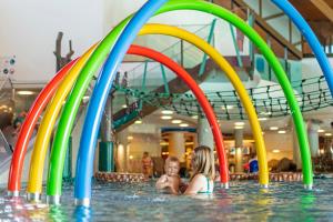 zwei Mädchen spielen in einem Pool mit bunten Pools in der Unterkunft Hotel Säntispark in St. Gallen