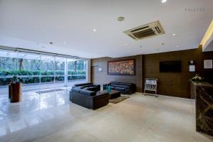 a large living room with couches and a tv at JK Residency Kelakam in Kelakam