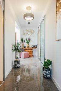 a hallway with potted plants and a table at Apartments Nora in Makarska