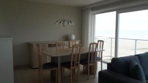 a kitchen and dining room with a table and chairs at Apartment Mirador 6 in Blankenberge