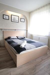 a bedroom with a large bed with two pillows on it at 01 Gdynia Centrum - Apartament Mieszkanie dla 2 os in Gdynia