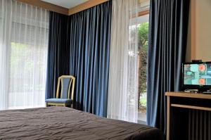 Postel nebo postele na pokoji v ubytování Residenza e Appartamenti Le Colonnine