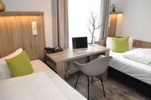 Postel nebo postele na pokoji v ubytování Hotel Perlach Allee by Blattl