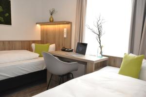 Postel nebo postele na pokoji v ubytování Hotel Perlach Allee by Blattl