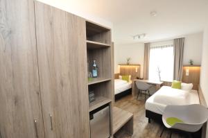 Postel nebo postele na pokoji v ubytování Hotel Perlach Allee by Blattl