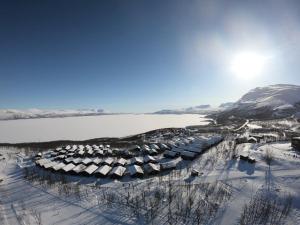 an aerial view of a resort in the snow at Kåppas Cabin Village in Björkliden