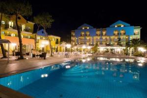 a large pool in front of a hotel at night at Hotel Parco Dei Principi in Grottammare