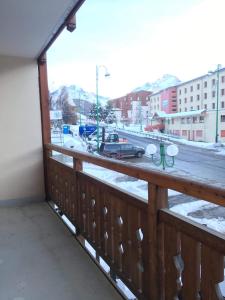 a balcony with a view of a snowy street at Boost Your Immo Les Deux Alpes Les Cimes 172 in Les Deux Alpes