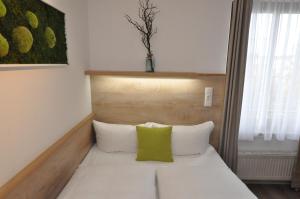 Postel nebo postele na pokoji v ubytování Hotel Perlach Allee by Blattl