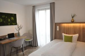 Postel nebo postele na pokoji v ubytování Hotel Perlach Allee by Blattl