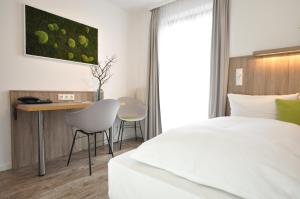 Postel nebo postele na pokoji v ubytování Hotel Perlach Allee by Blattl