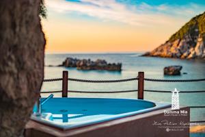 a bath tub with a view of the ocean at Damma Mia in Damouchari