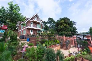 a house with a garden in front of it at The Pine Yard in Kalaw