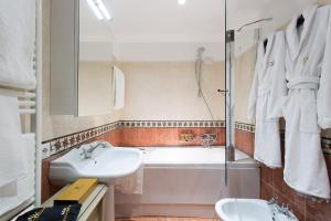 a bathroom with a tub and a sink and a shower at GKK Exclusive Private suite Venezia in Venice +23 photos