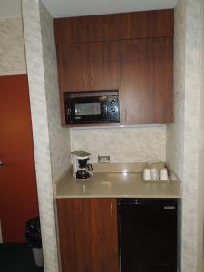 a kitchen with a microwave and a sink at The Breakers Resort Inn in Virginia Beach