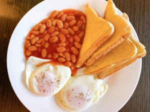 a white plate with eggs beans beans and toast at Sitio Uno Residences in Roxas City