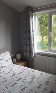 a bedroom with a bed and a window at Carnoustie Lodge in Wisbech