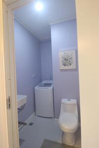 a white bathroom with a toilet and a sink at One Rodney Heights Condominiums in Gros Islet
