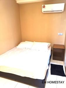 a bedroom with a bed and a air freshener at EM HOMESTAY(Coral Bay 3Room Apartment) in Pangkor