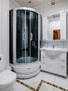 a bathroom with a shower and a toilet and a sink at Hotel 21 Vek in Astrakhan