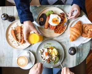 a group of people eating breakfast on a table at The Pilgrm in London