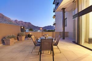 a patio with a table and chairs on a balcony at G Zero 3 @ The Breakers in Hout Bay