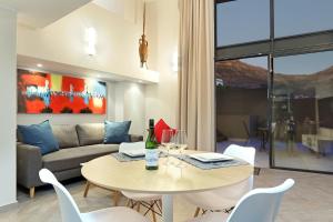 a living room with a table and a couch at G Zero 3 @ The Breakers in Hout Bay