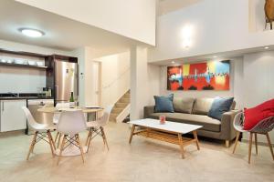 a living room with a couch and a table and chairs at G Zero 3 @ The Breakers in Hout Bay +15 photos