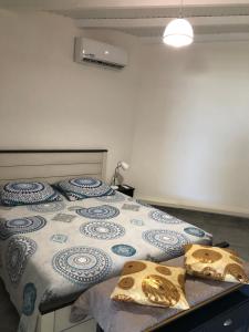a bedroom with a bed with a blue and white quilt at Belcourt1-lit queen size in Baie-Mahault