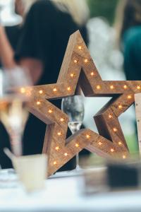 a wooden star on a table with lights at Villa de l'Etang Blanc in Seignosse