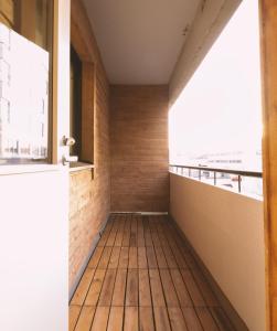 a room with a wooden floor and windows at Apartment Rovakatu 27 B 10 in Rovaniemi