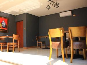 a dining room with wooden chairs and a table at Thavhani boutique hotel in Thohoyandou