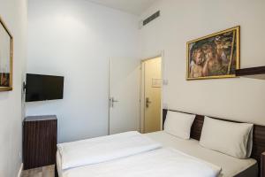 Postel nebo postele na pokoji v ubytování Hotel Assenzio Prague