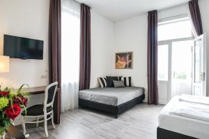 Postel nebo postele na pokoji v ubytování Hotel Assenzio Prague