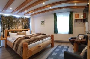 a bedroom with a large bed and a window at Naturtraum Georgshöhe in Thale