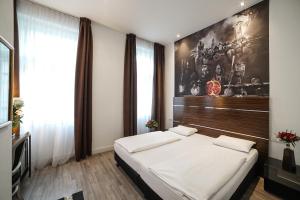 Postel nebo postele na pokoji v ubytování Hotel Assenzio Prague