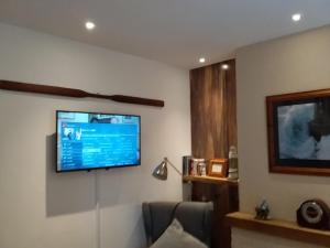 Cette chambre dispose d'une télévision murale à écran plat. dans l'établissement Castle Hill Cottage & Paddlers Retreat, à Ballywalter