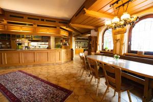 a kitchen with a table and chairs in a room at Gasthaus zum Rössel Lichtenau in Scherzheim