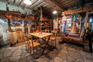 a dining room with a table and chairs in a building at Authentic Countryside Villa with Hot tub in Veliki Kamen