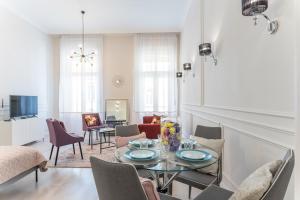 sala de estar con mesa y sillas en Milano Design Apartment City Center, en Budapest